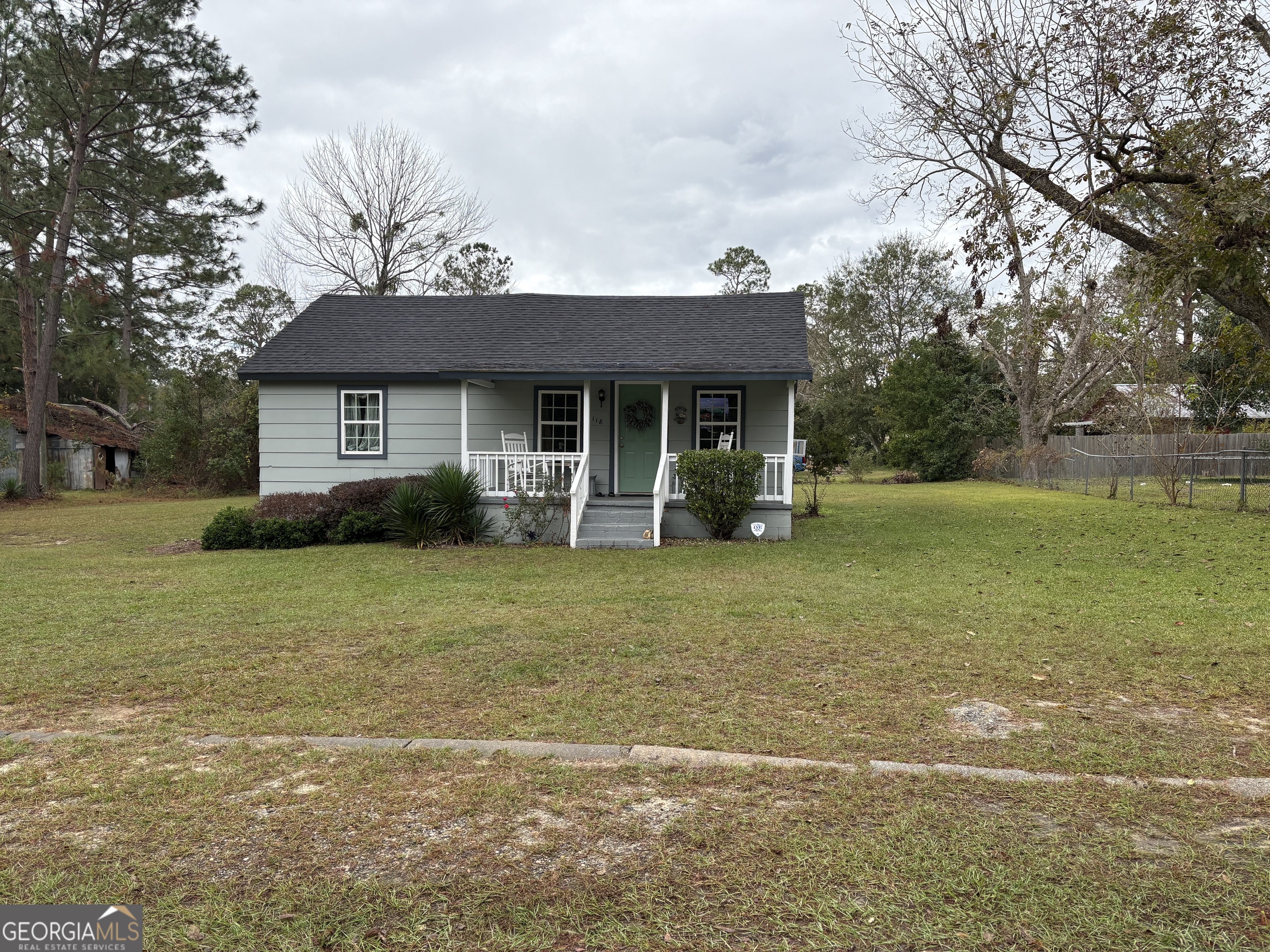 a front view of house with yard and trees