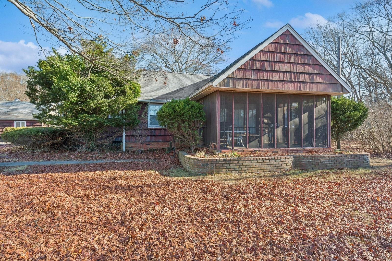 View of property exterior featuring a sunroom