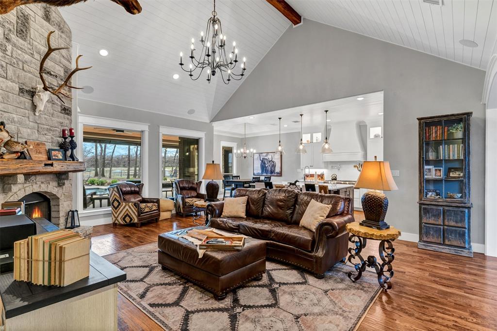 a living room with fireplace furniture and a chandelier