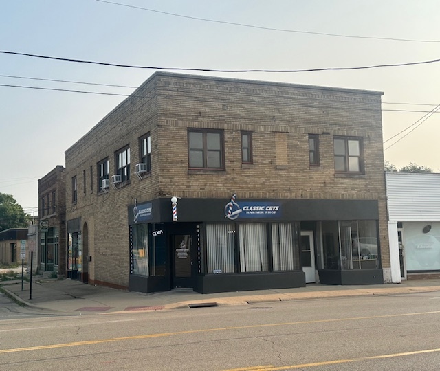 a front view of building with yard