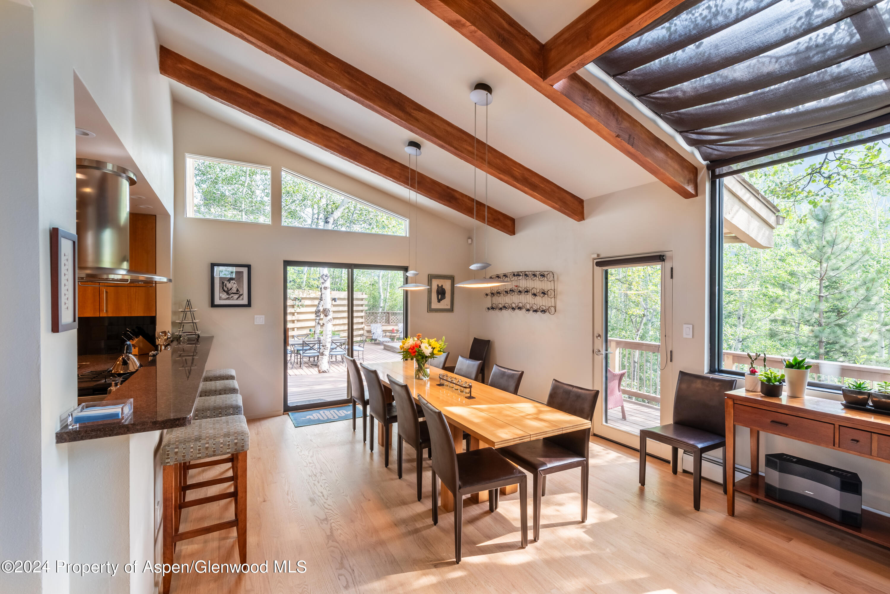 a dining room with furniture water view and a floor to ceiling window