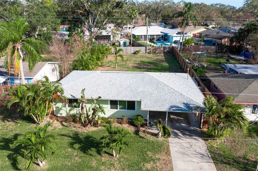 an aerial view of a house with a yard basket ball court and outdoor seating