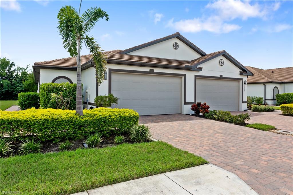 a front view of a house with a yard and garage