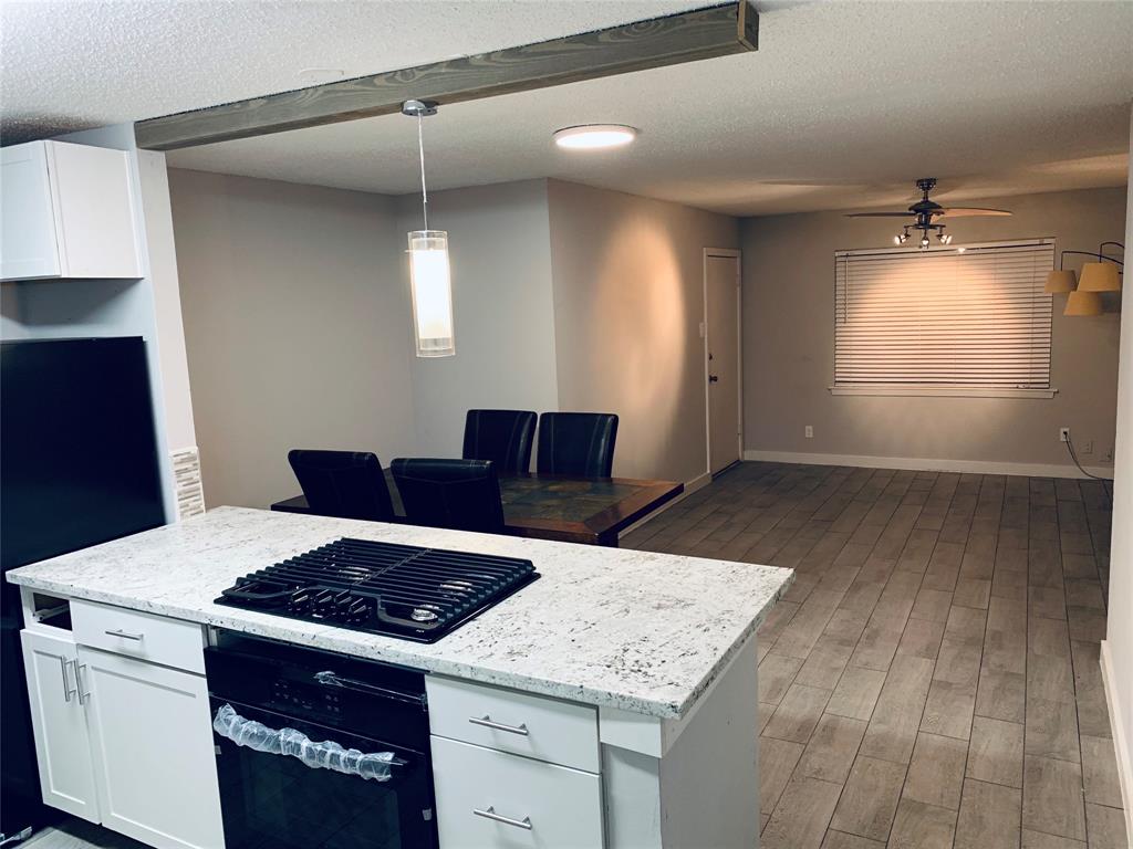 a kitchen with a stove a sink and a refrigerator