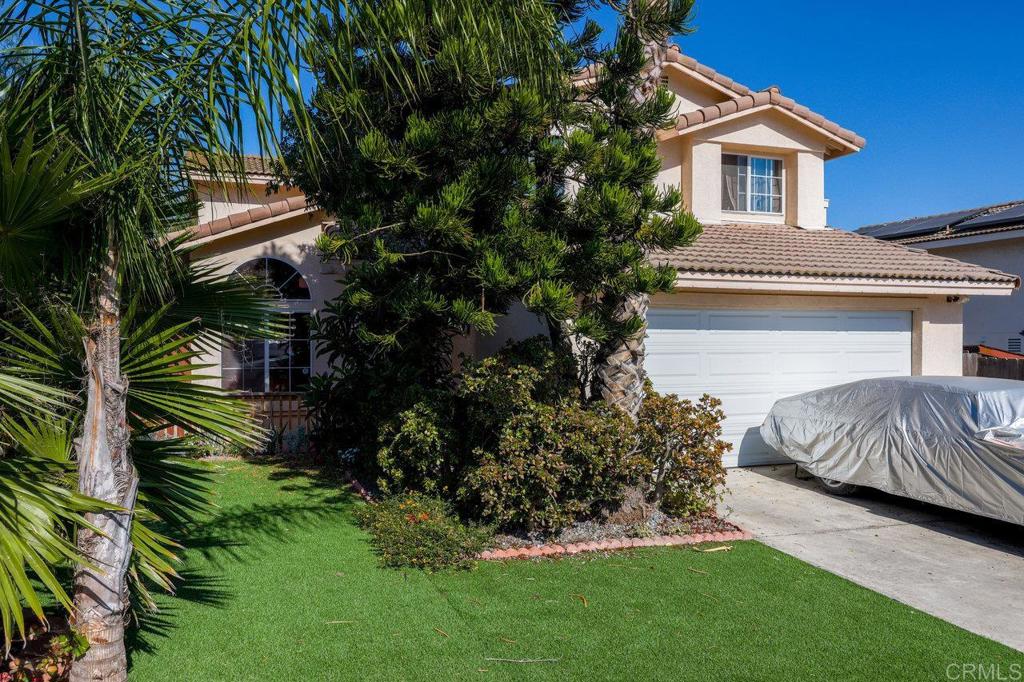 a front view of a house with a garden