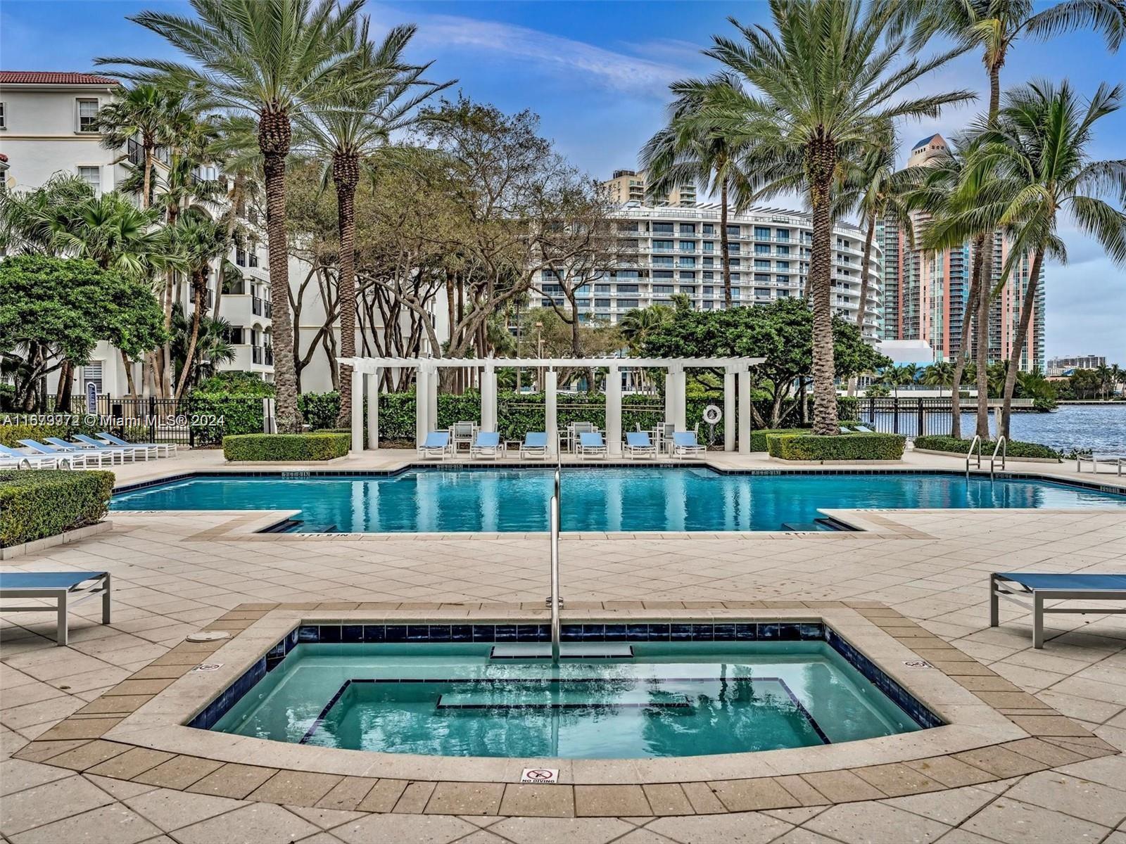 a house view with a swimming pool and sitting area