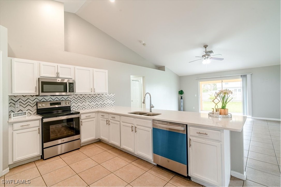 a kitchen with stainless steel appliances granite countertop a sink and cabinets