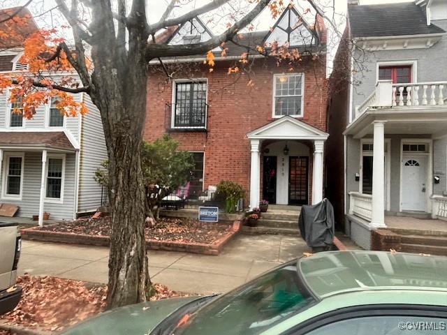 a front view of a house with yard porch and furniture