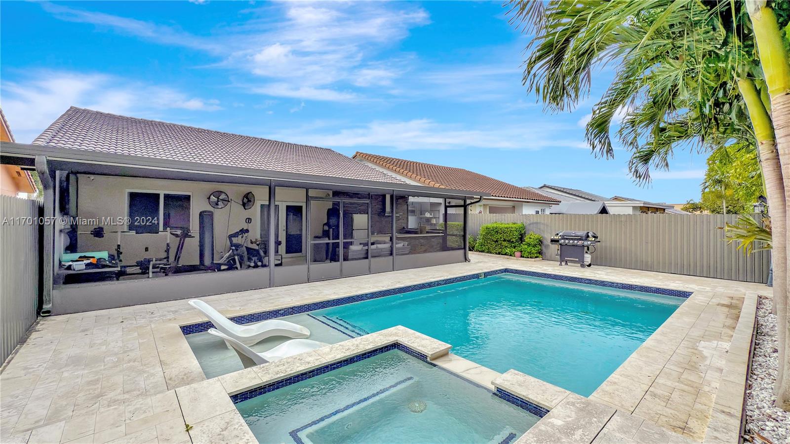 a view of a house with swimming pool and sitting area