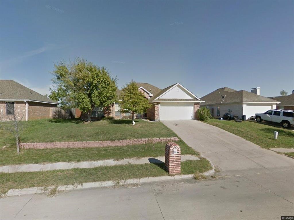 Ranch-style house with a front yard and a garage