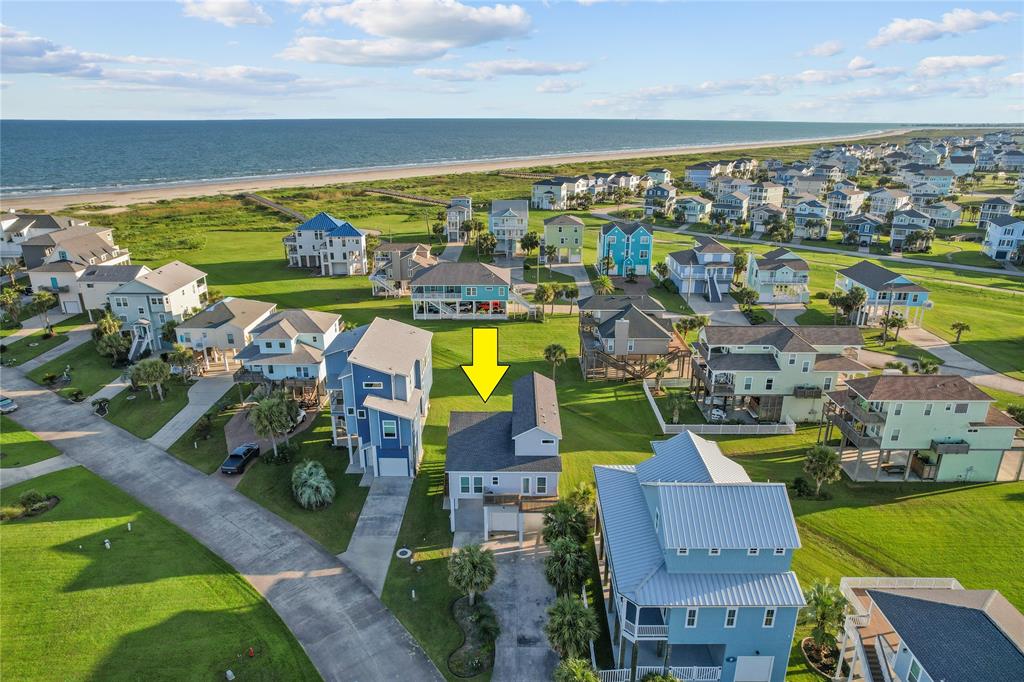 an aerial view of residential houses with outdoor space and swimming pool