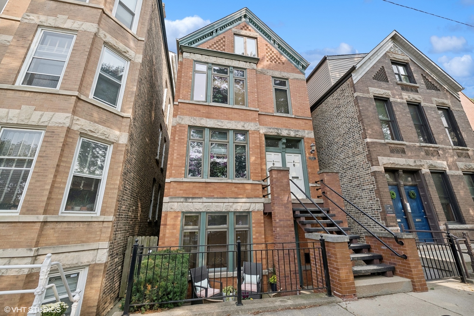 a front view of a residential apartment building with a yard