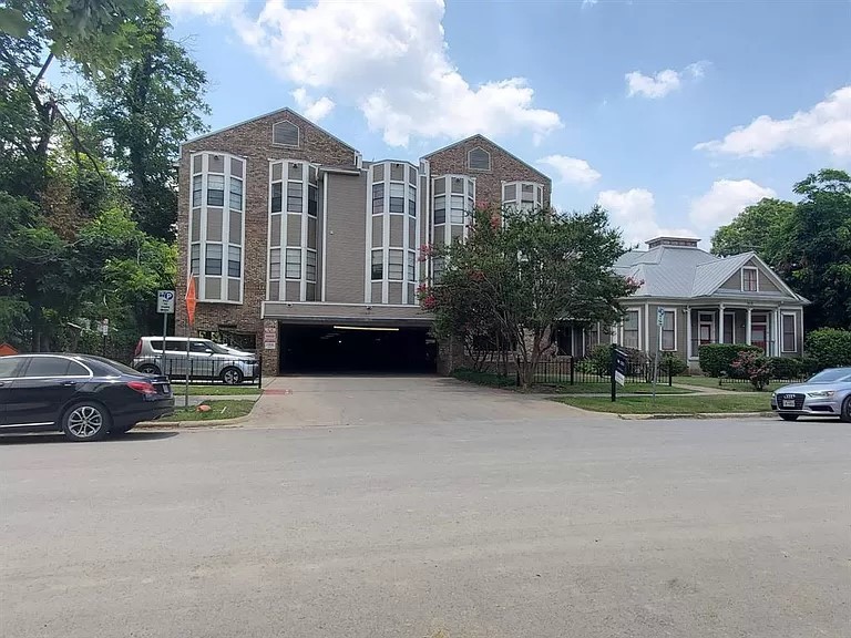 a view of house with outdoor space and parking