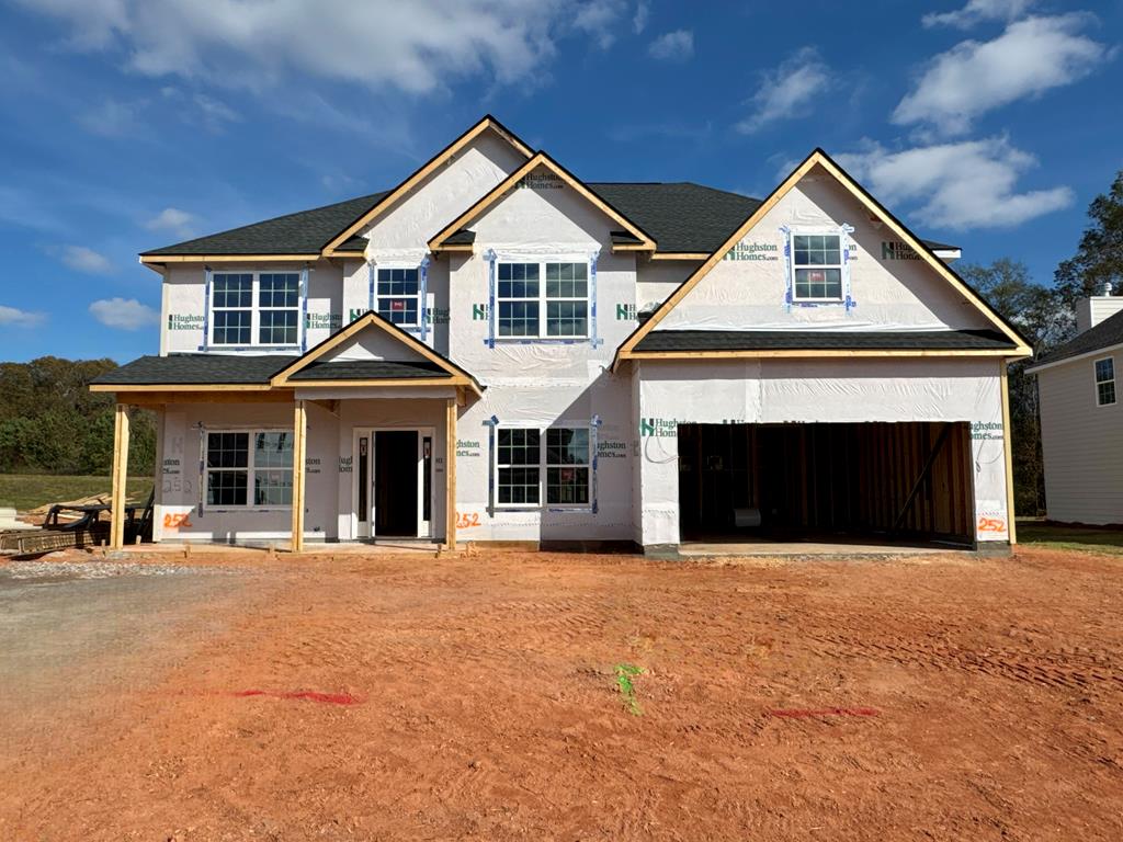 a front view of a house with yard and garage