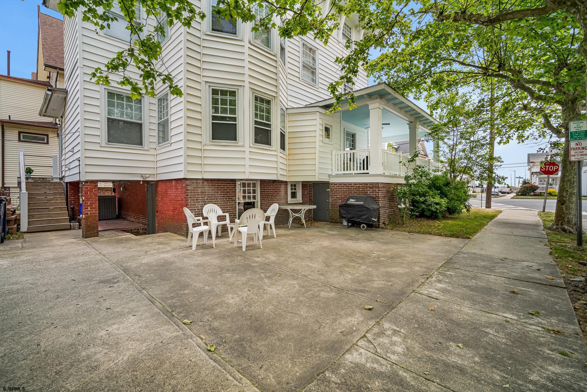 a view of a house with a patio and a yard