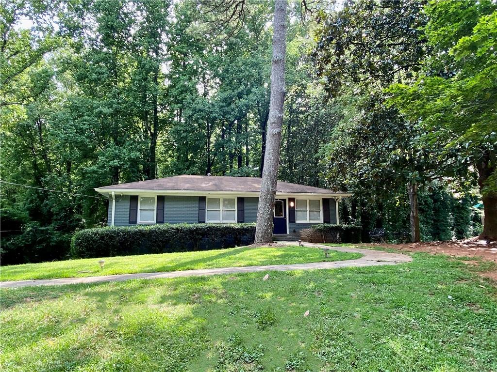 a front view of house with yard and green space