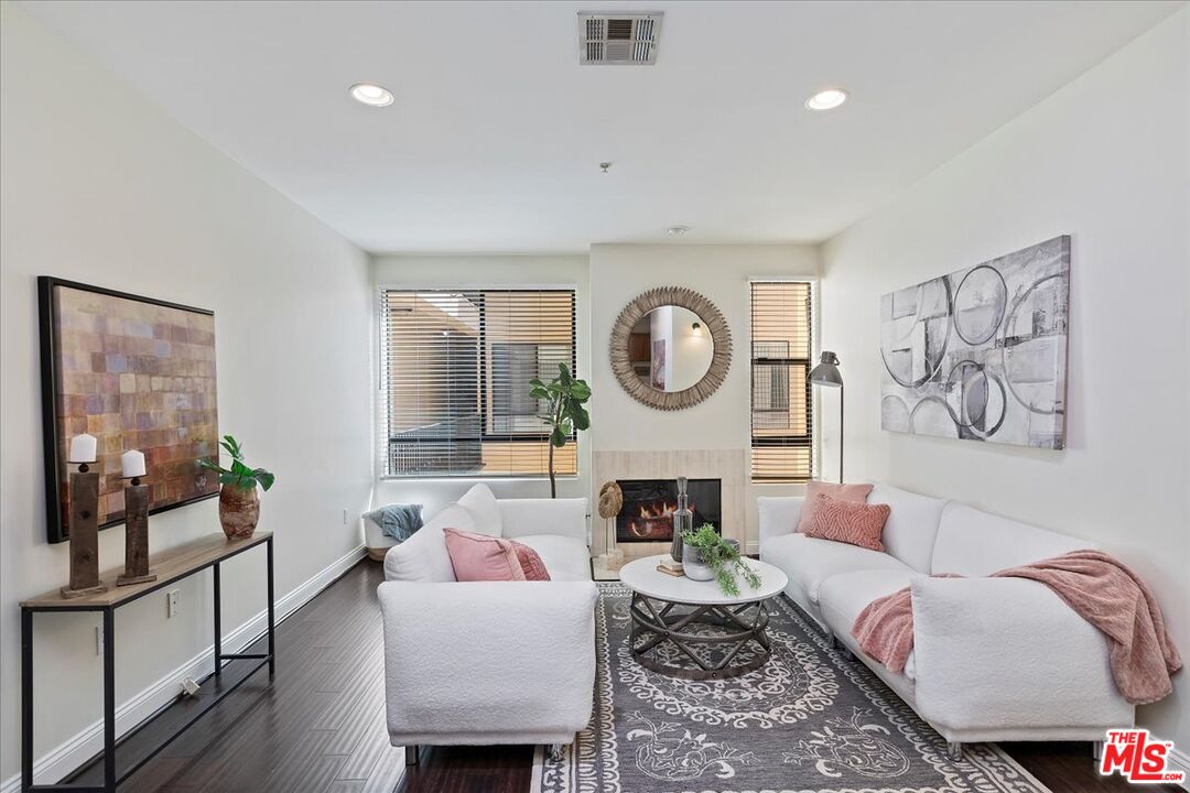 a living room with furniture a rug and a fireplace