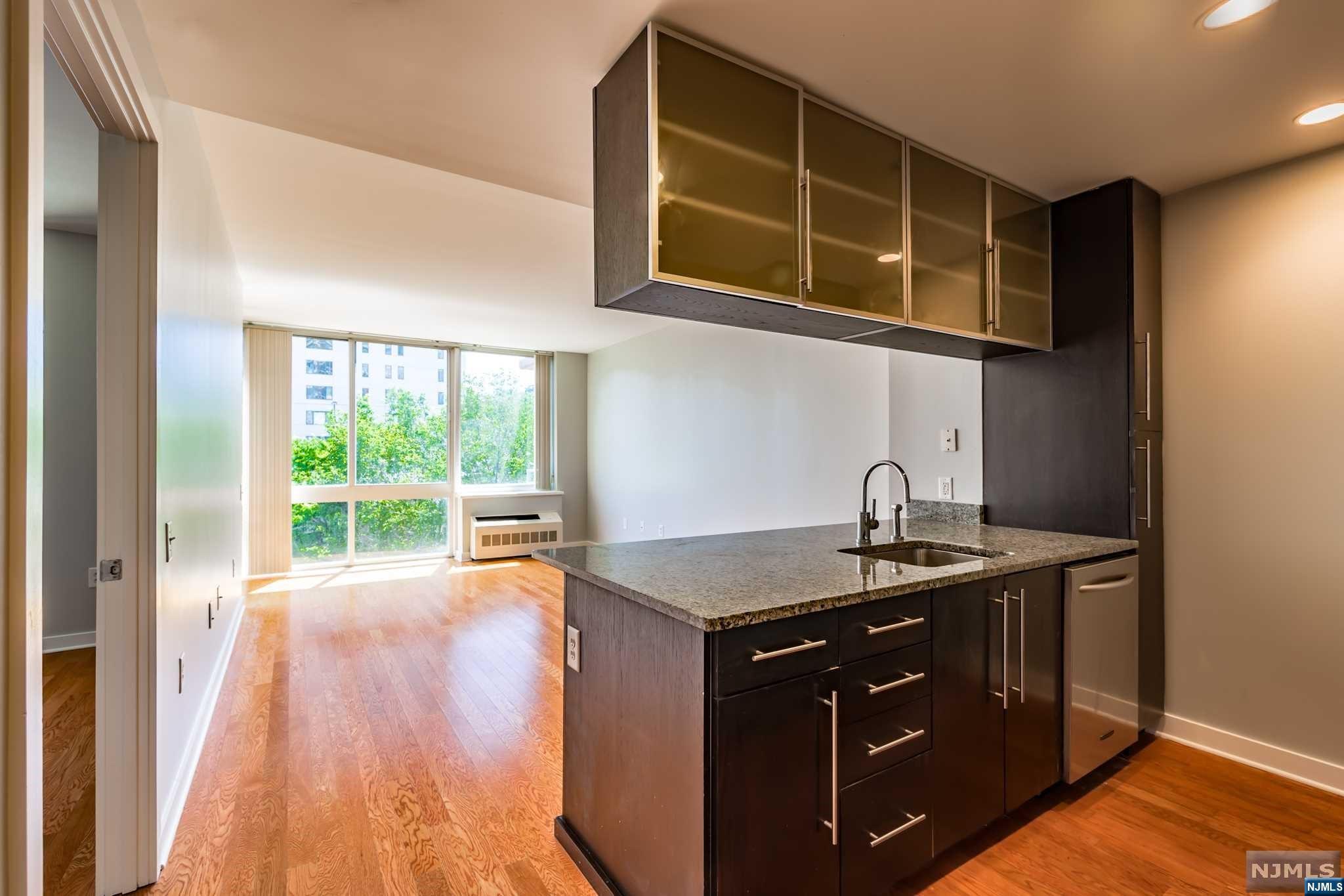 a kitchen with a wooden floor and a sink