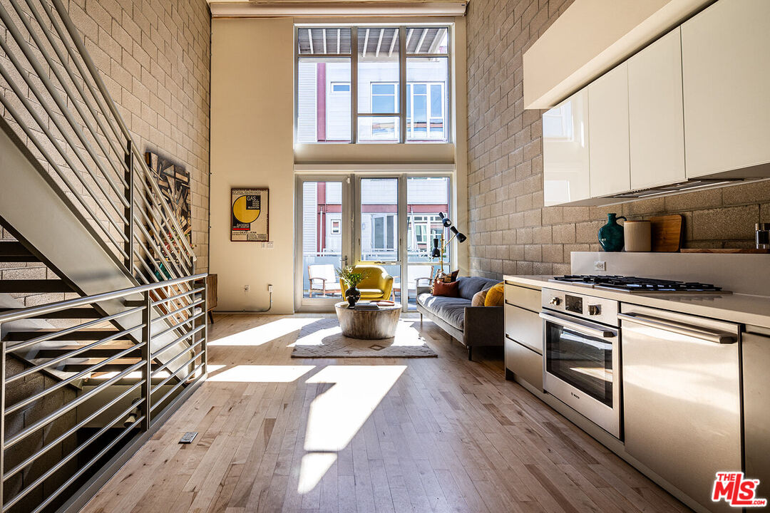 a kitchen with stainless steel appliances granite countertop a stove and a refrigerator