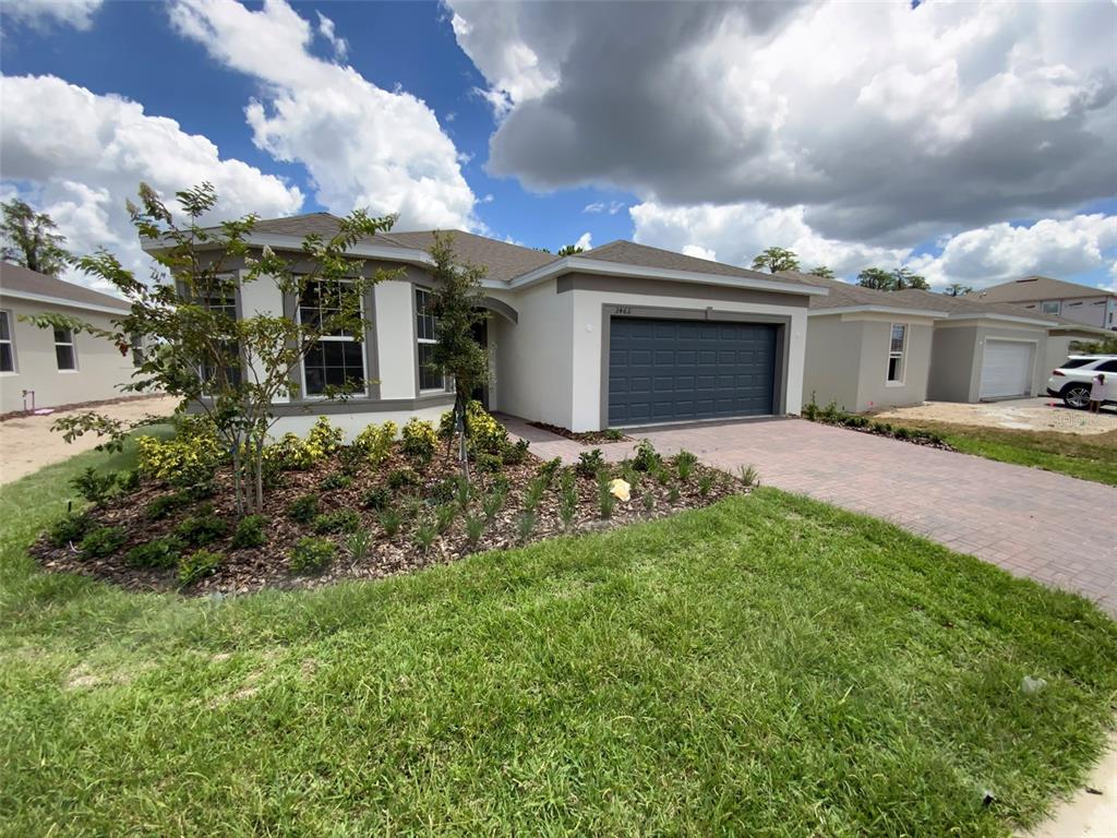 a front view of a house with a yard and garage