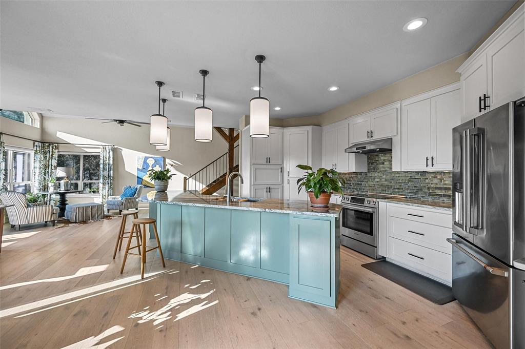 a kitchen with stove and cabinets