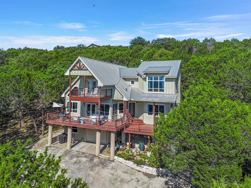 a aerial view of a house with a yard balcony and sitting area