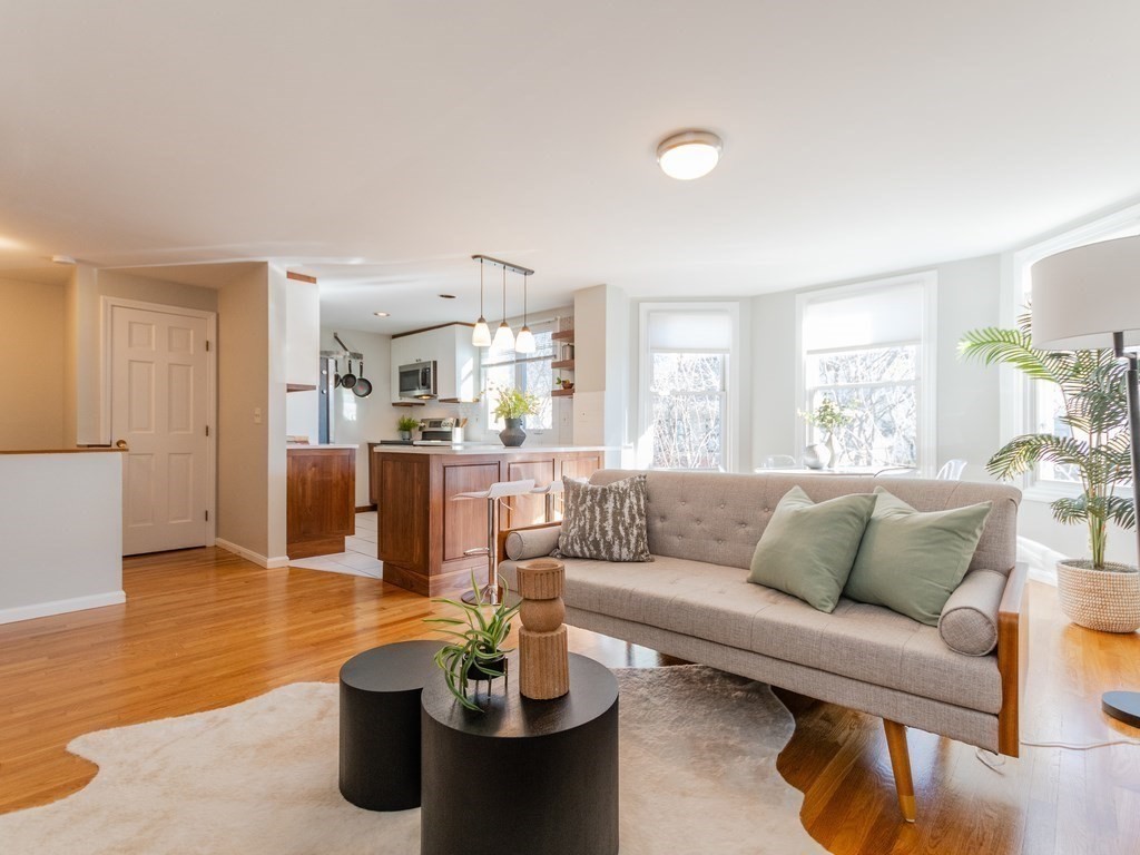 a living room with furniture and kitchen view