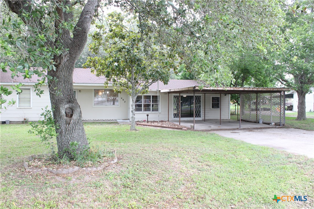 a front view of a house with a garden and porch