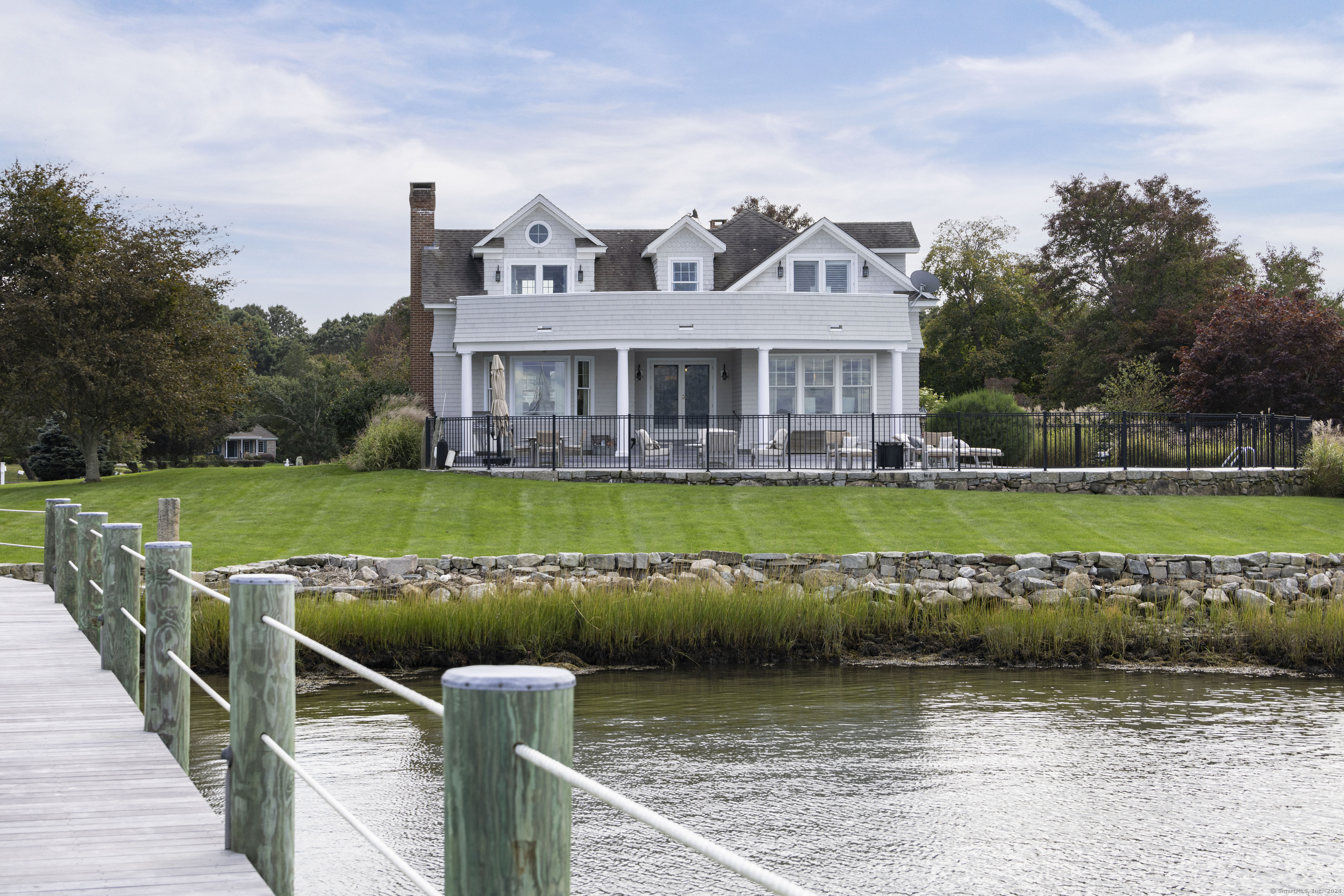 a view of a house with a garden and lake view