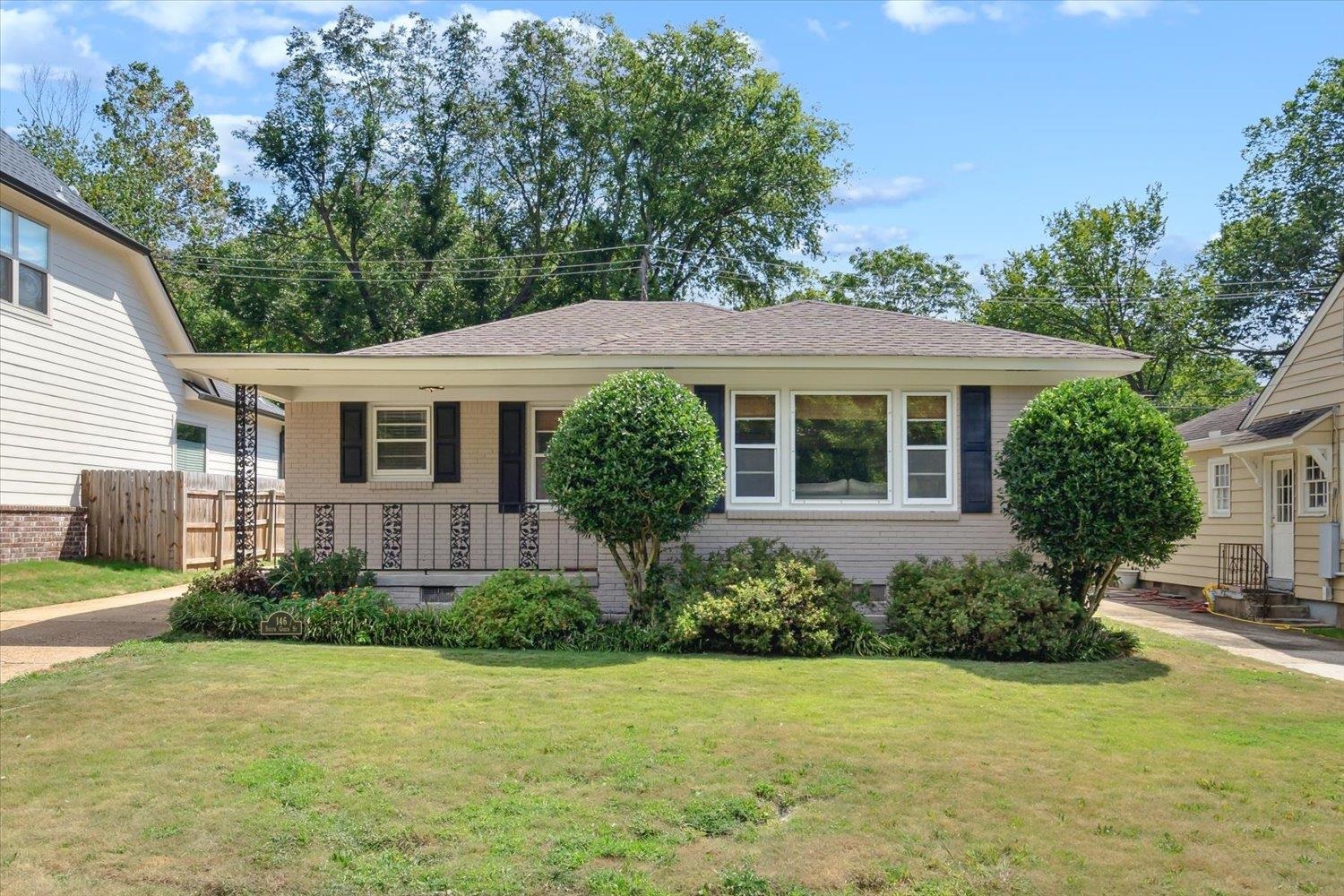 a front view of a house with a garden