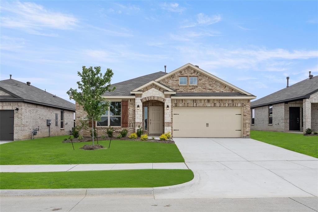 a front view of a house with a yard and garage