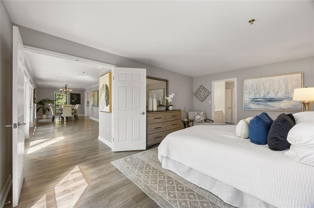 a bedroom with a large bed and a view of living room