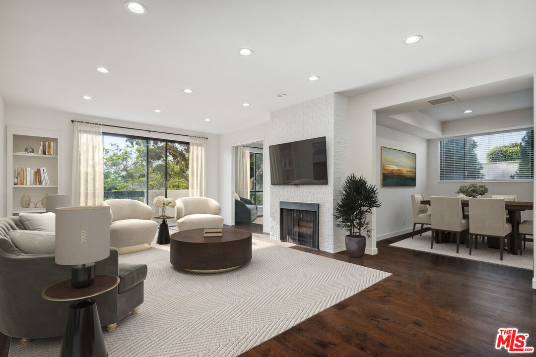 a living room with fireplace furniture and a flat screen tv