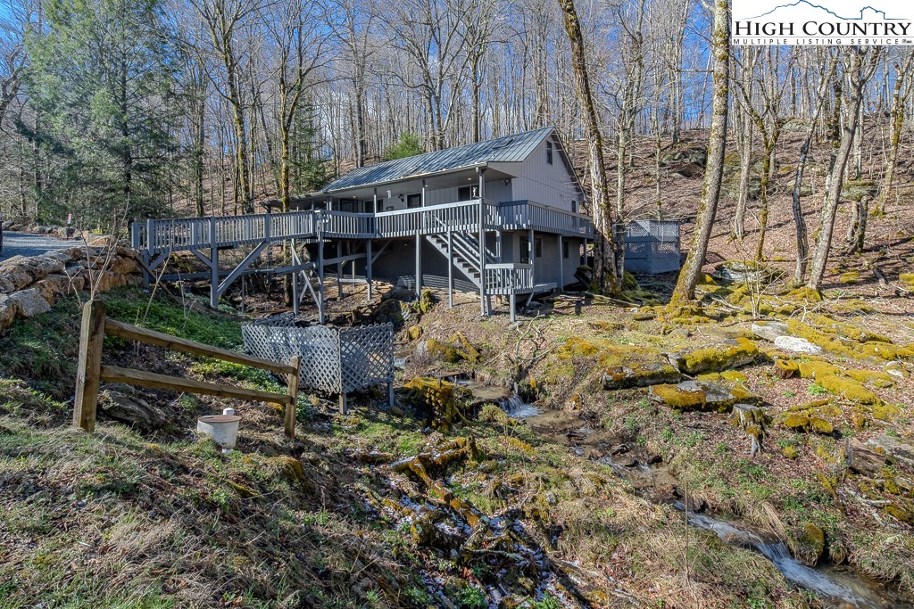 a view of house with a yard covered with trees