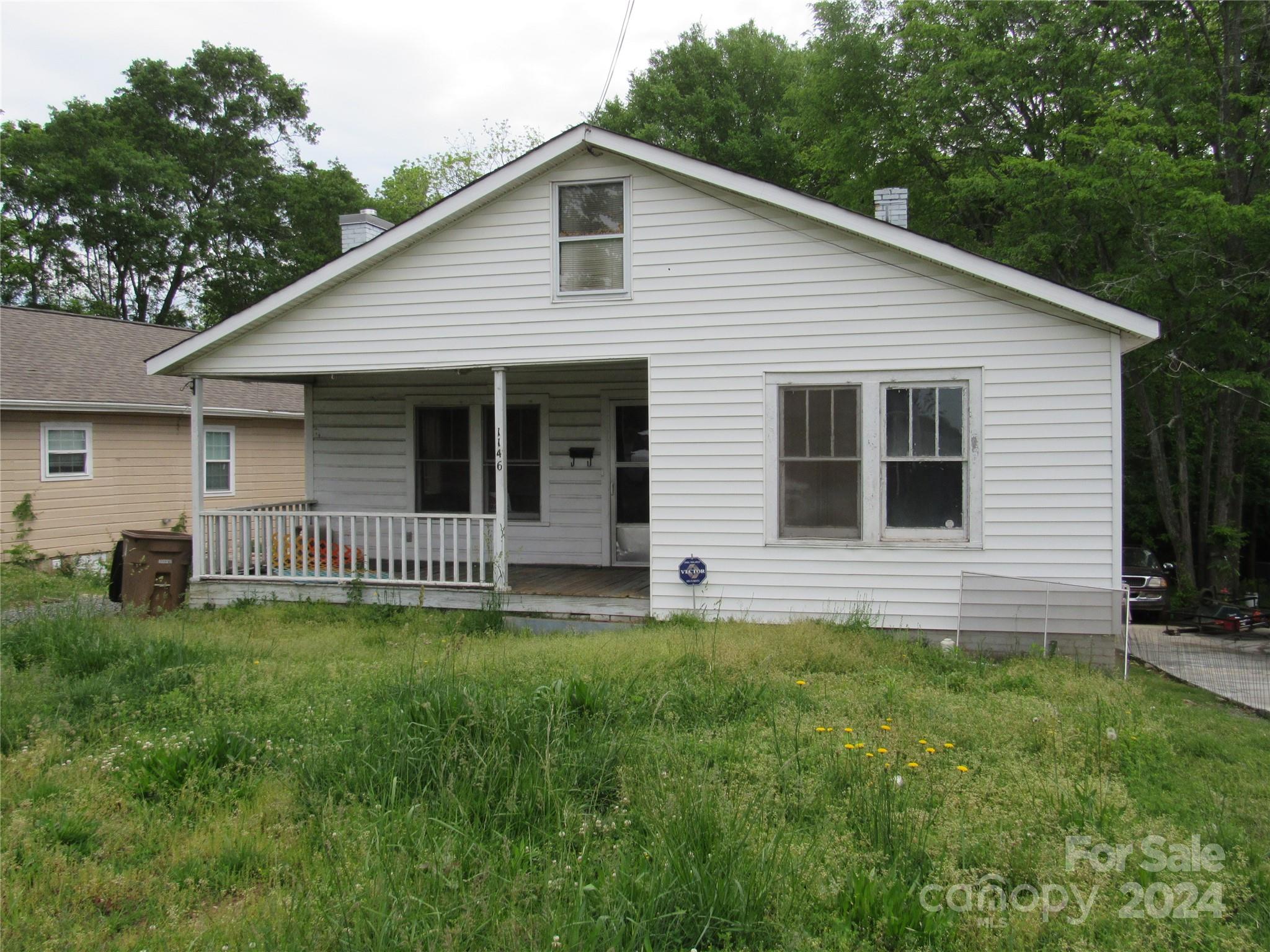 a view of a house with a yard and a garden