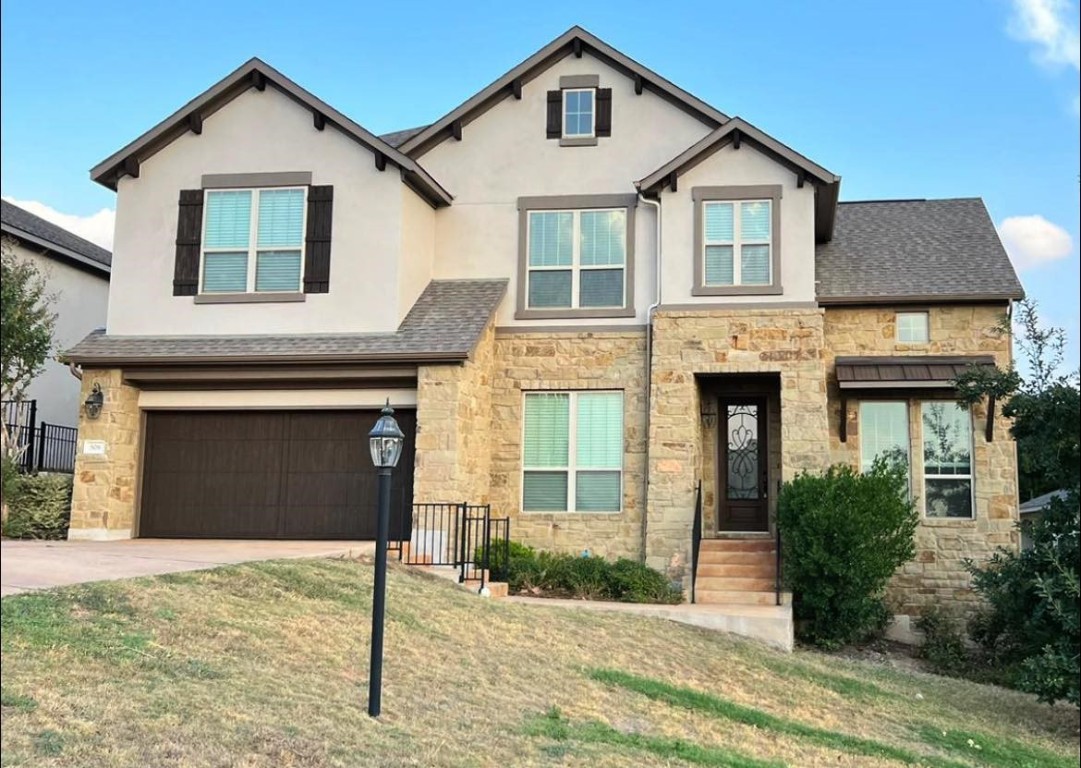 a front view of a house with a yard and garage