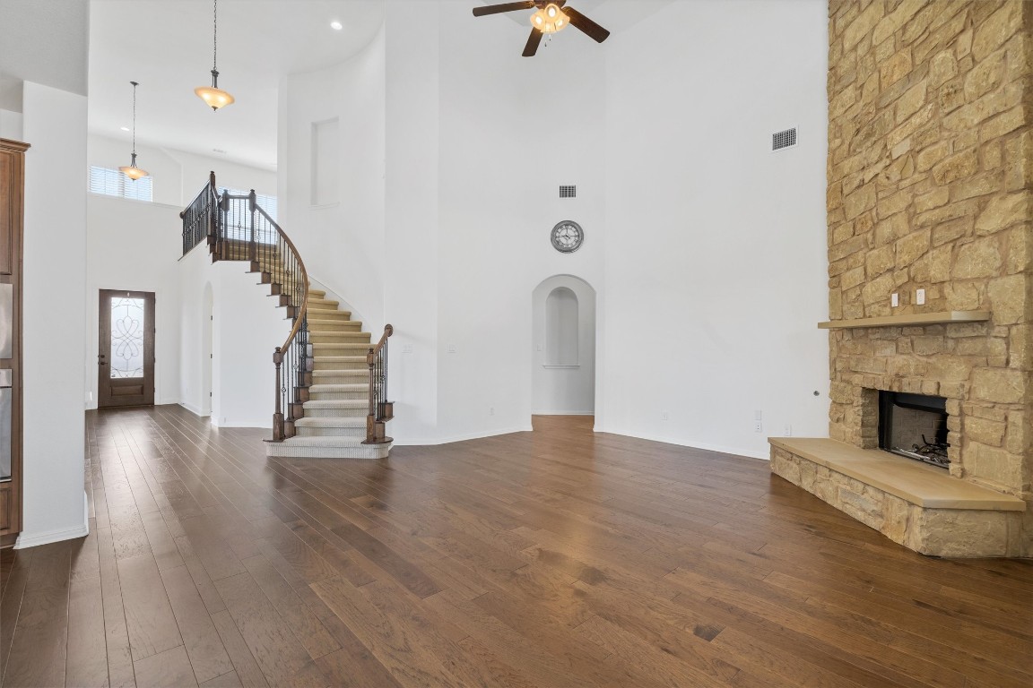 a view of a livingroom with wooden floor and a fireplace