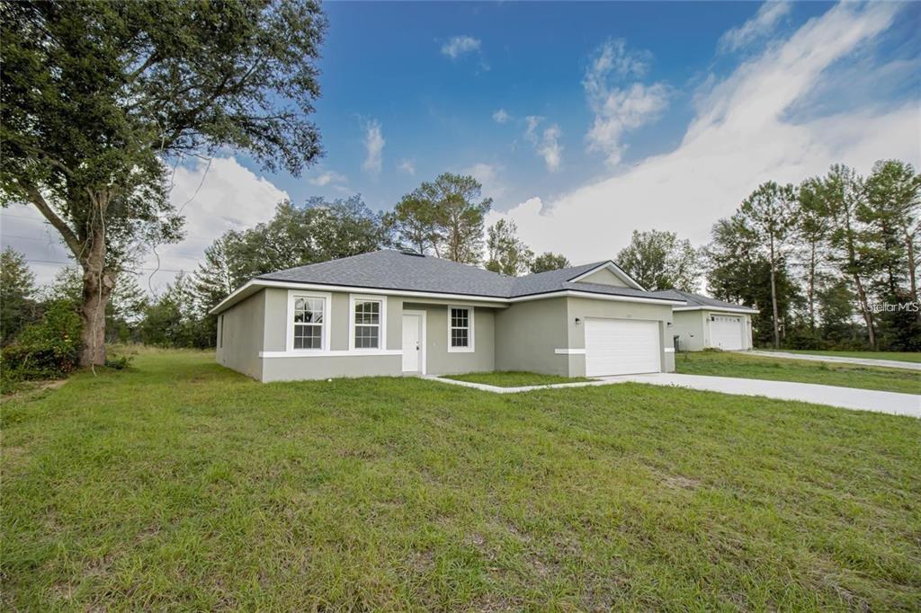 a view of a house with a yard