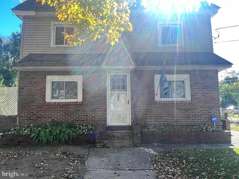 a view of brick house with a yard