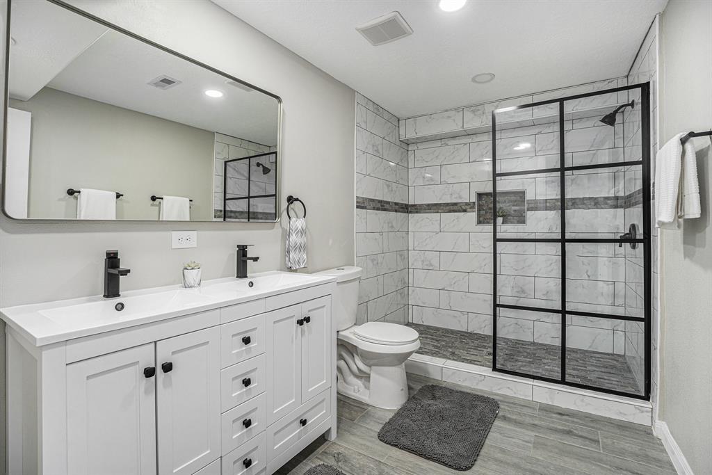 a bathroom with a sink toilet and shower