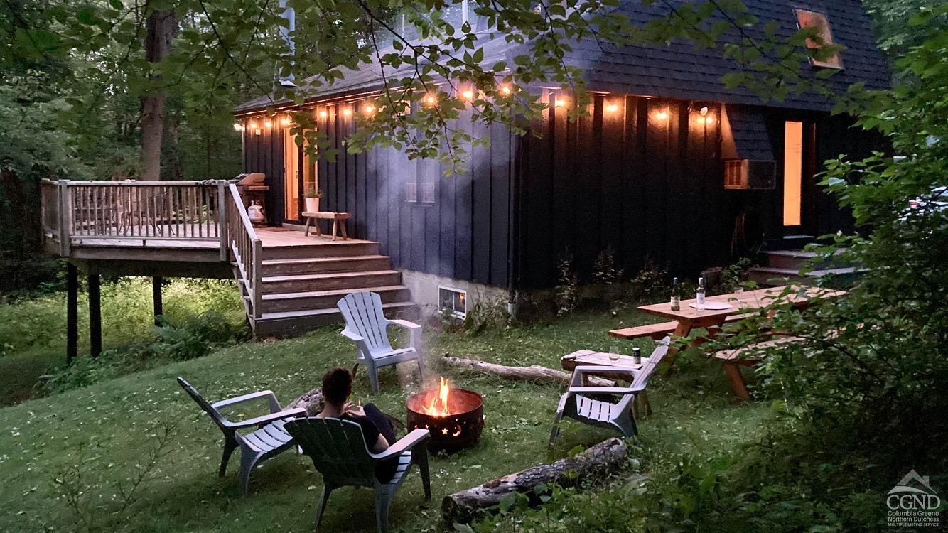 a view of a chairs and table in backyard of the house