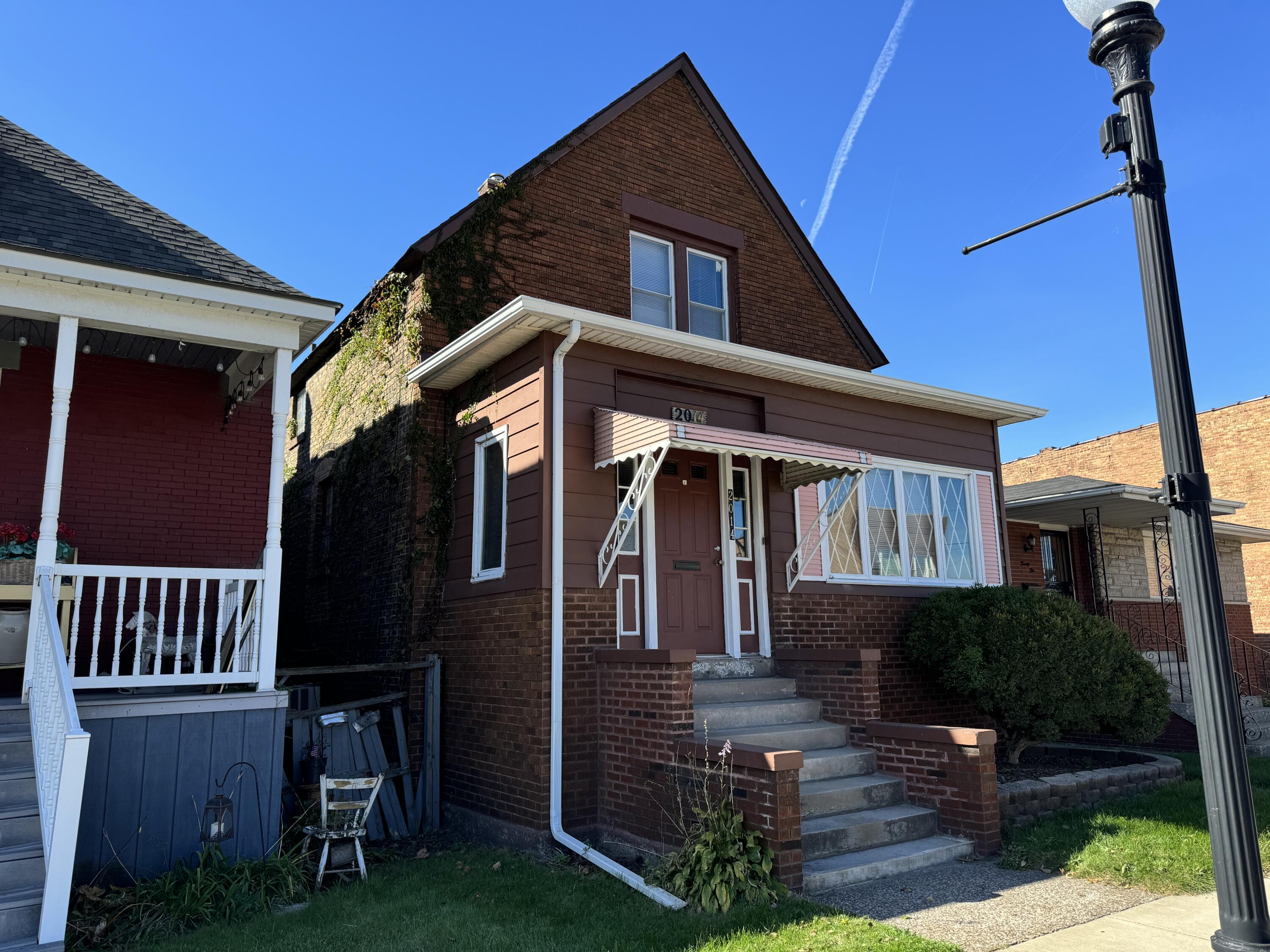 a front view of a house with garden