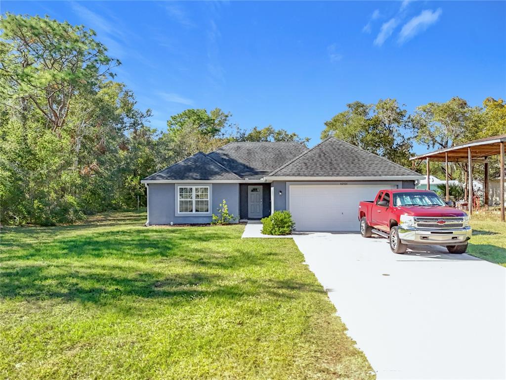 a view of a house with a back yard