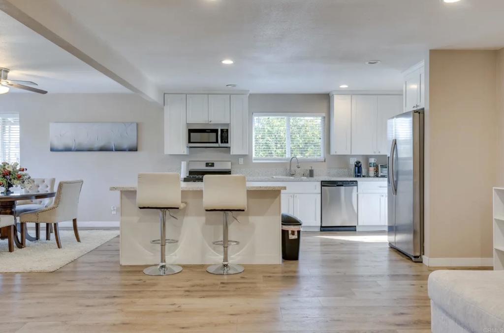 a kitchen with a sink cabinets and wooden floor