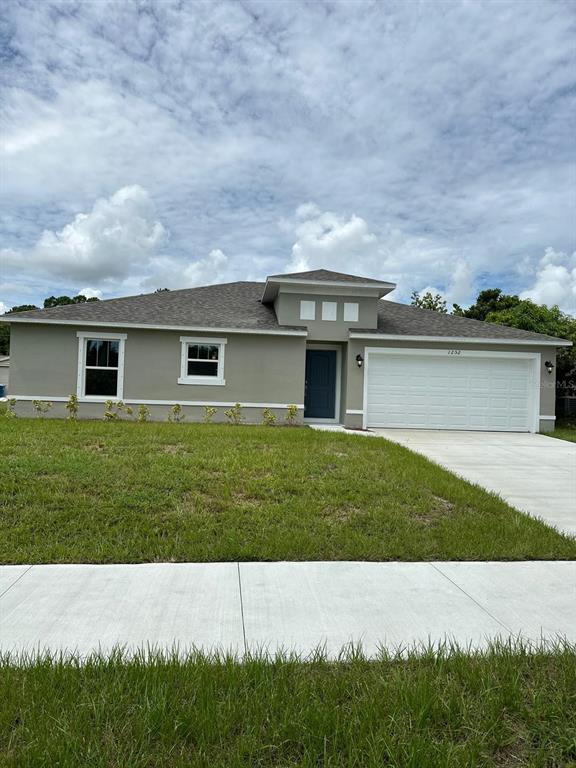 a view of a house with a backyard