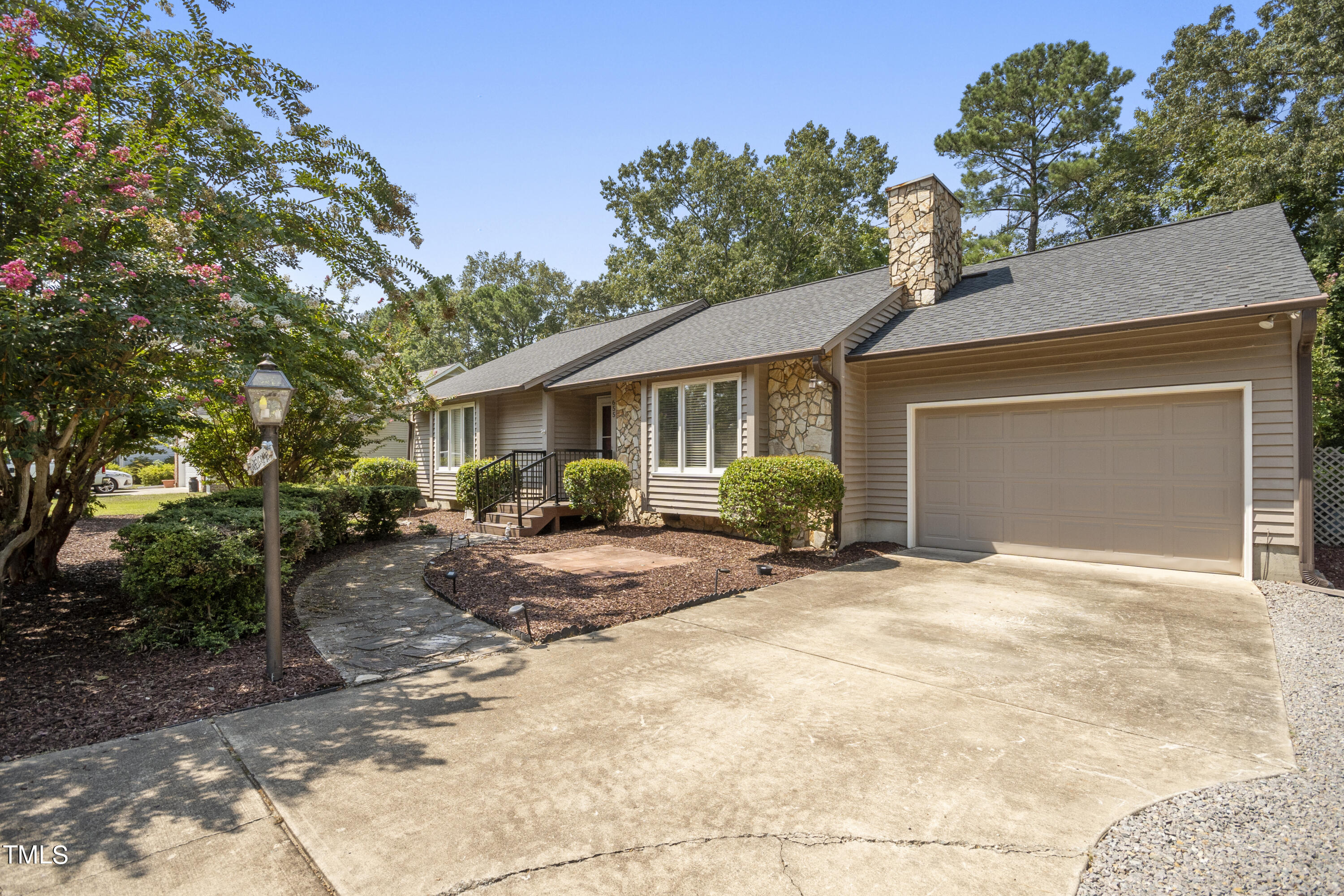 a view of a house with a yard and garage