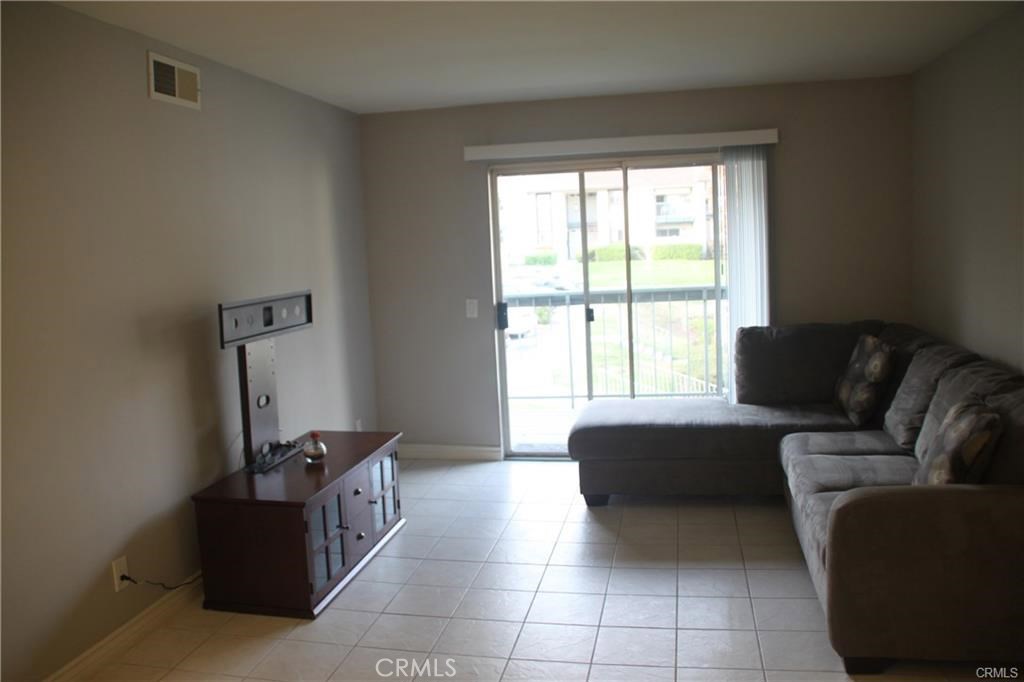 a living room with a couch and a window