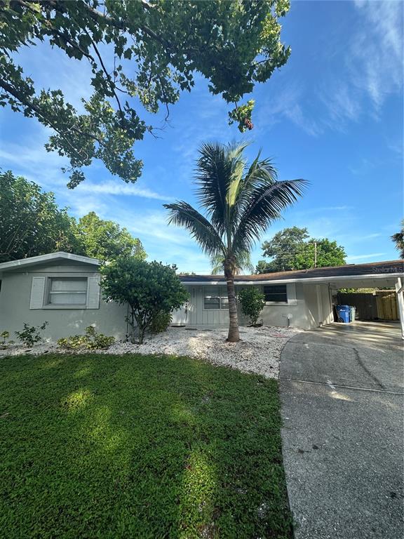 a front view of house with yard and trees