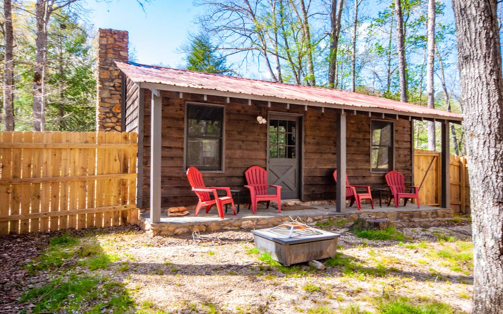 a view of a patio with table and chairs and wooden fence