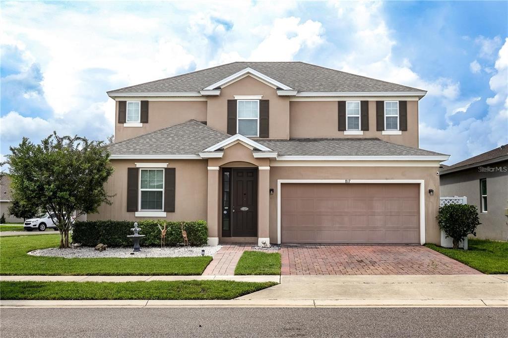 a front view of a house with a yard and garage